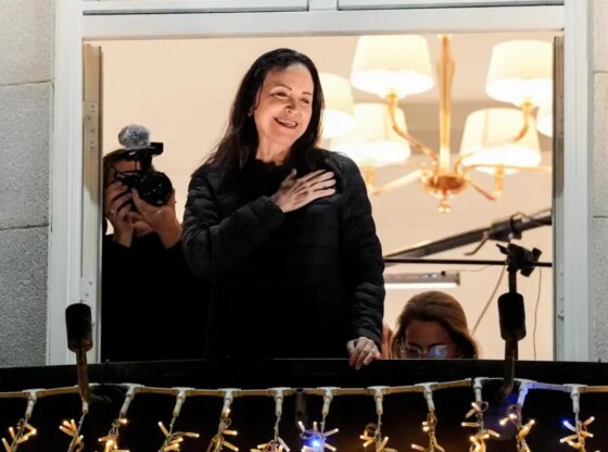 Nobel Peace Prize winner María Corina Machado gestures from the balcony of the Grand Hotel in Oslo, Norway, on December 11, 2025.