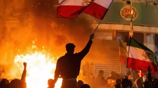 Protesters burn vehicles in Kaj Square in Tehran, Iran.