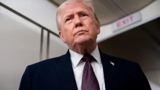 U.S. President Donald Trump speaks with members of the media aboard Air Force One en route from Florida to Joint Base Andrews, Maryland, U.S., Jan. 11, 2026.