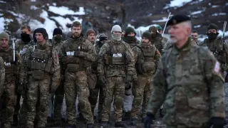 Danish soldiers take part in an exercise near the Buksefjord hydroelectric power station, during the visit of Danish Defense Minister Troels Lund Poulsen.