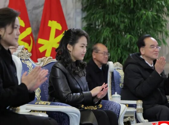 Kim Jong-un's daughter, center, applauds North Korean troops during the military parade.