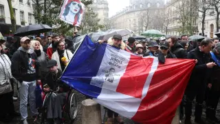 People gather to pay tribute to Quentin, an activist who died from injuries sustained during a beating, during a demonstration in Paris.