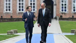 Frenchman Emmanuel Macron and German Friedrich Merz talk during the summit at the Belgian castle of Alden Biesen