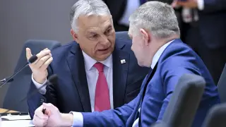 Hungarian Viktor Orbán chats with his Slovak ally, Robert Fico, during a European Council in Brussels