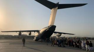 A group of Afghan refugees board a Spanish Army A400M plane at Kabul airport.